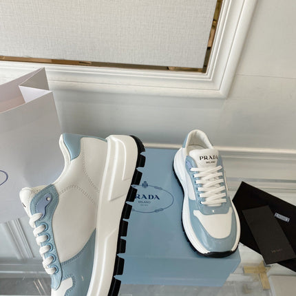 PRADA 25S THICK SOLE SNEAKER IN WHITE AND LIGHT BLUE CALFSKIN