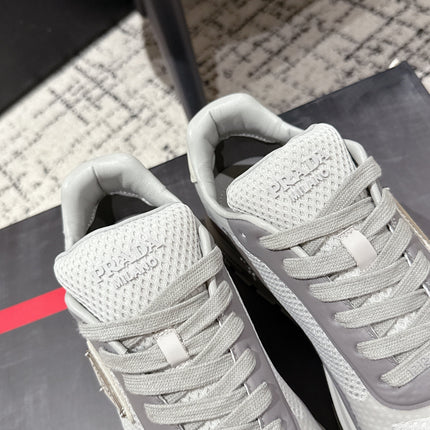 PRADA 25S MEN SNEAKERS IN GRAY AND WHITE CANVAS