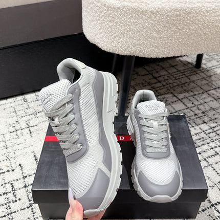 PRADA 25S MEN SNEAKERS IN GRAY AND WHITE CANVAS