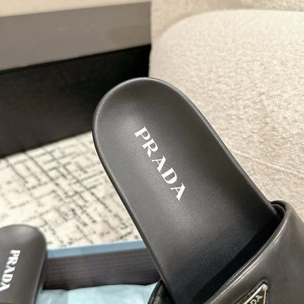 PRADA 25S PADDED SLIDES IN BLACK CALFSKIN WITH LOGO