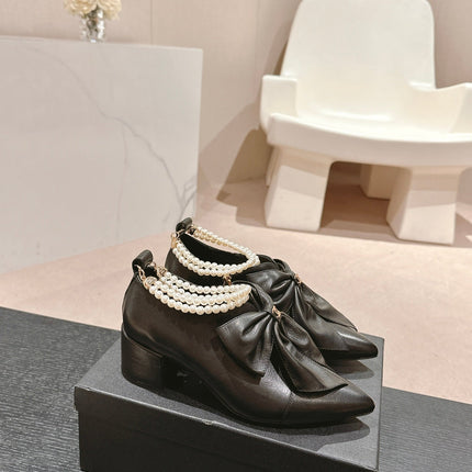 SHORT BOOTS IN BLACK SHEEPSKIN WITH BOW