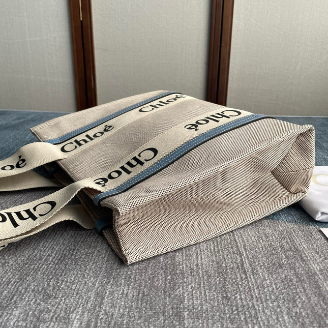 MEDIUM STRAP WOODY TOTE BAG 37 IN BEIGE LINEN CANVAS BLACK WEBBING LOGO EMBROIDER BLUE CALFSKIN