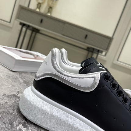OVERSIZED SNEAKER IN BLACK CALFSKIN WITH SILVER STITCHED WHITE HEEL TAB