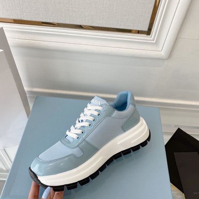 PRADA 25S THICK SOLE SNEAKER IN LIGHT BLUE CALFSKIN AND CANVAS