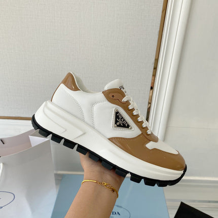 PRADA 25S THICK SOLE SNEAKER IN WHITE AND BROWN CALFSKIN