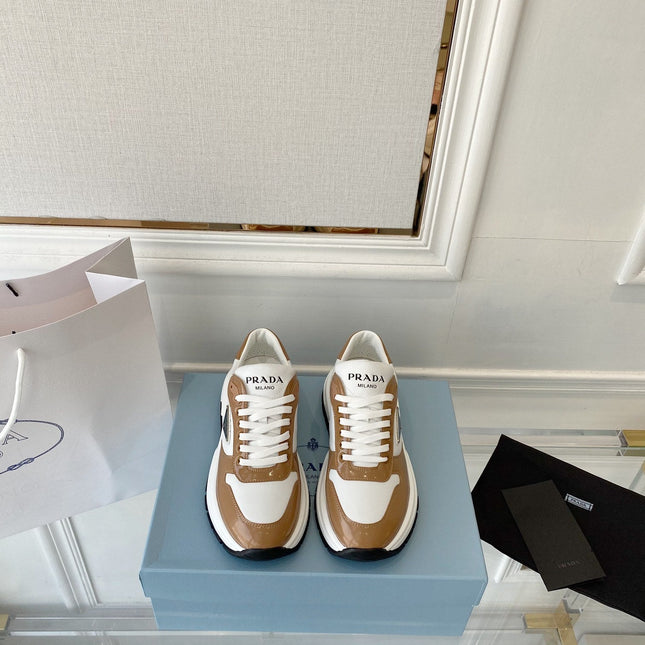 PRADA 25S THICK SOLE SNEAKER IN WHITE AND BROWN CALFSKIN