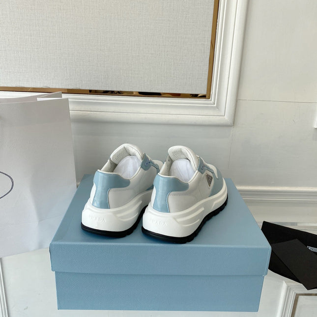 PRADA 25S THICK SOLE SNEAKER IN WHITE AND LIGHT BLUE CALFSKIN
