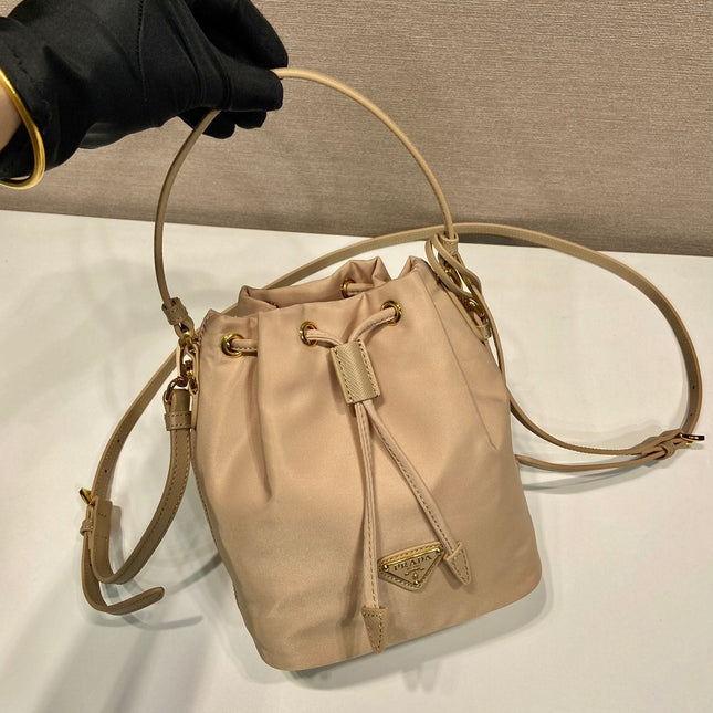 BUCKET BAG 19 IN BEIGE RE-NYLON AND SAFFIANO LEATHER HANDLE