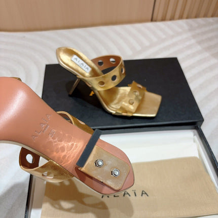 ALAIA TWO-STRAPS HIGH HEEL SANDALS IN GOLDEN PATENT LAMBSKIN
