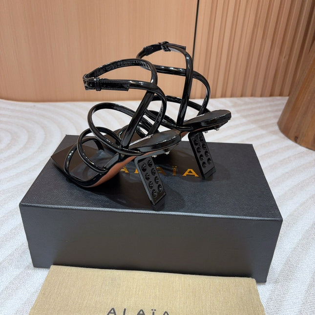 ALAIA THREE-STRAPS HIGH HEEL SANDALS IN BLACK PATENT LAMBSKIN