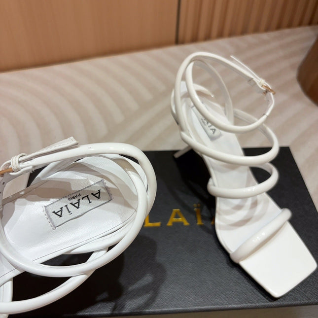 ALAIA THREE-STRAPS HIGH HEEL SANDALS IN WHITE PATENT LAMBSKIN
