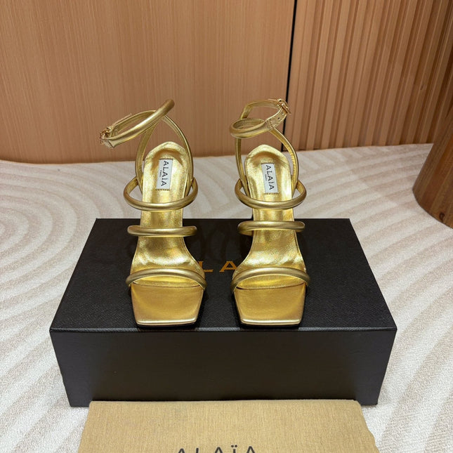 ALAIA THREE-STRAPS HIGH HEEL SANDALS IN GOLDEN PATENT LAMBSKIN