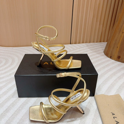 ALAIA THREE-STRAPS HIGH HEEL SANDALS IN GOLDEN PATENT LAMBSKIN