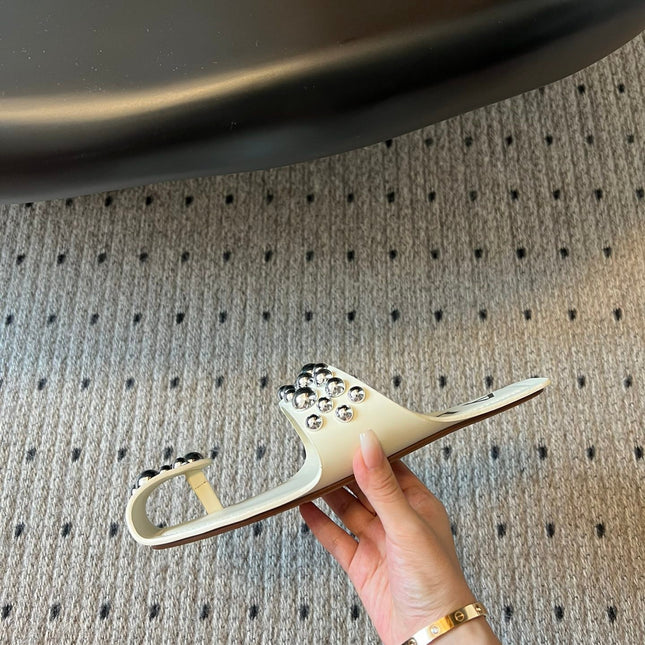 ALAIA FOLDED FLAT MULES WITH SPHERES ON WHITE CALFSKIN