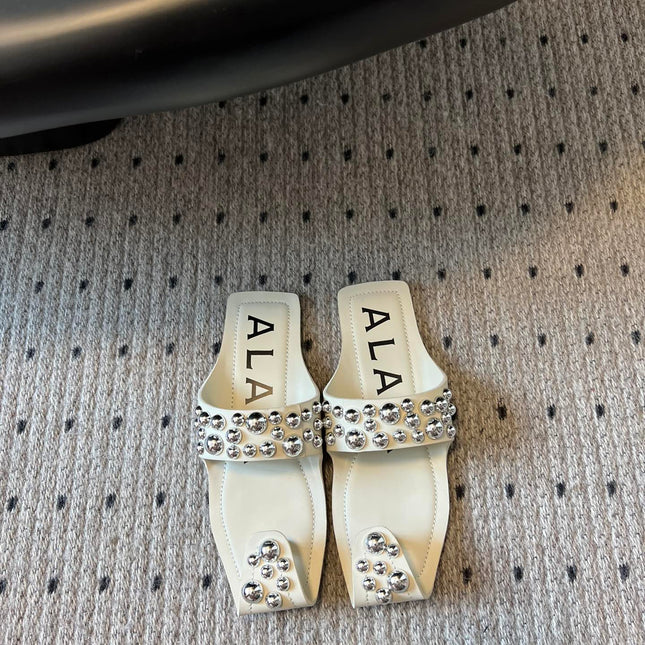 ALAIA FOLDED FLAT MULES WITH SPHERES ON WHITE CALFSKIN