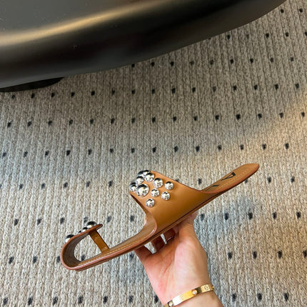 ALAIA FOLDED FLAT MULES WITH SPHERES ON COPPER BROWN CALFSKIN