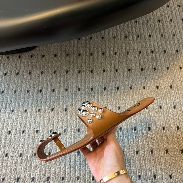 ALAIA FOLDED FLAT MULES WITH SPHERES ON COPPER BROWN CALFSKIN