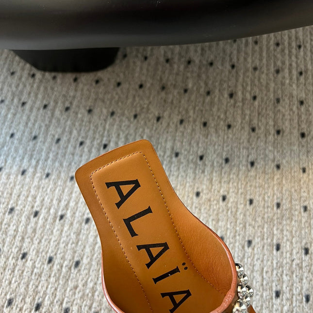 ALAIA FOLDED FLAT MULES WITH SPHERES ON COPPER BROWN CALFSKIN