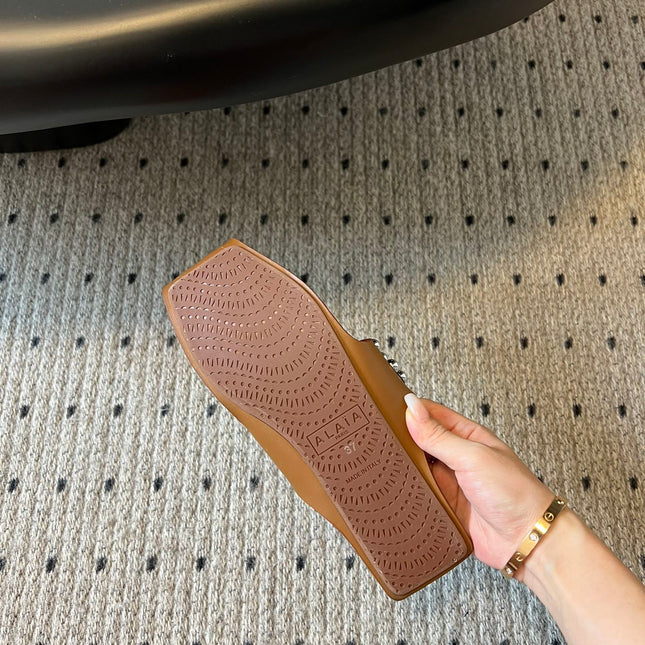 ALAIA FOLDED FLAT MULES WITH SPHERES ON COPPER BROWN CALFSKIN