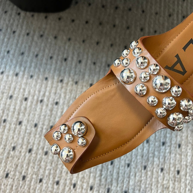 ALAIA FOLDED FLAT MULES WITH SPHERES ON COPPER BROWN CALFSKIN