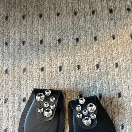 ALAIA FOLDED FLAT MULES WITH SPHERES ON BLACK CALFSKIN
