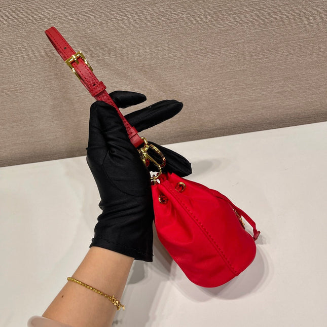 MINI BUCKET BAG 10 IN RED RE-NYLON AND SAFFIANO LEATHER STRAP