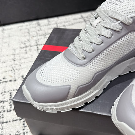PRADA 25S MEN SNEAKERS IN GRAY AND WHITE CANVAS