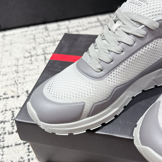PRADA 25S MEN SNEAKERS IN GRAY AND WHITE CANVAS