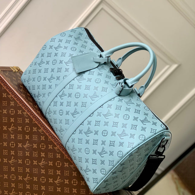 KEEPALL BANDOULIÈRE 50 IN SKY BLUE MONOGRAM SHADOW EMBOSSED CALFSKIN