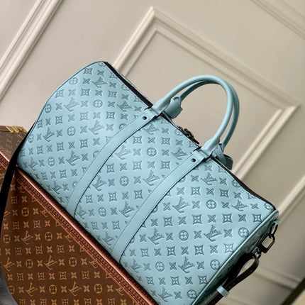 KEEPALL BANDOULIÈRE 50 IN SKY BLUE MONOGRAM SHADOW EMBOSSED CALFSKIN