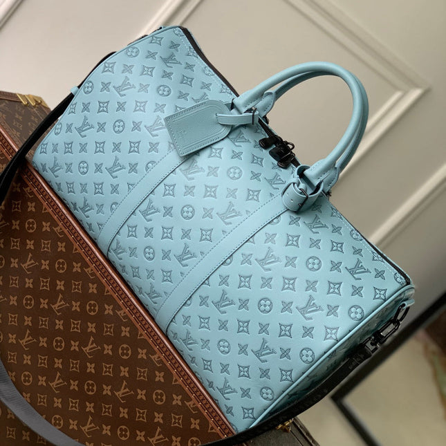 KEEPALL BANDOULIÈRE 50 IN SKY BLUE MONOGRAM SHADOW EMBOSSED CALFSKIN