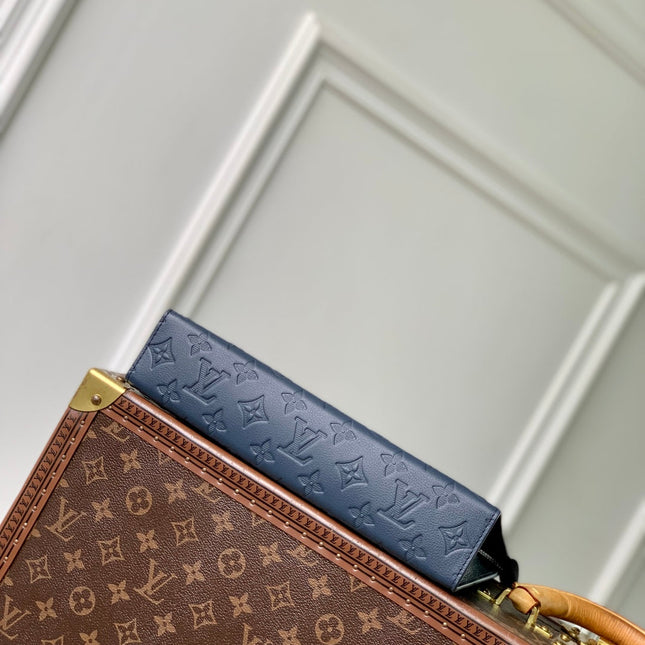POCHETTE VOYAGE 27 IN DARK BLUE MONOGRAM ECLIPSE CALFSKIN EMBOSSED LOGO