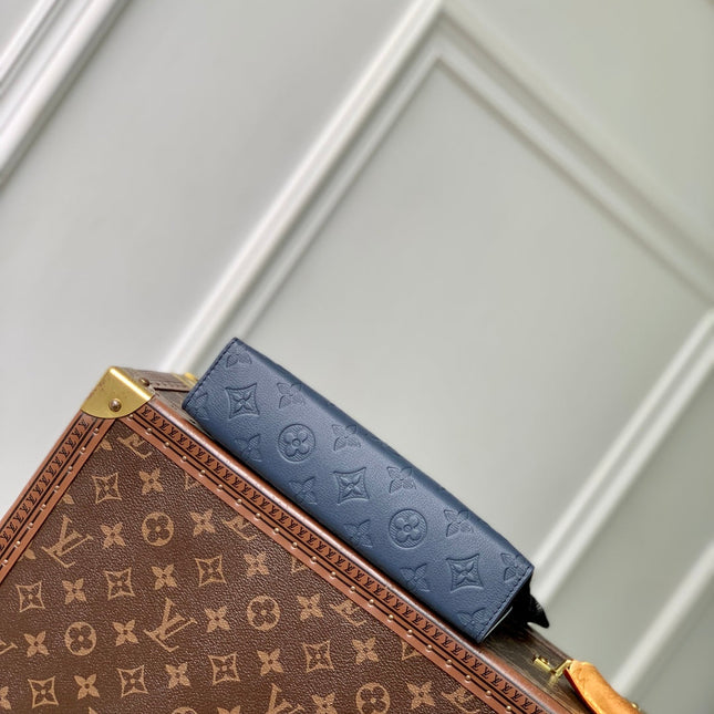 POCHETTE VOYAGE 22 IN DARK BLUE MONOGRAM SHADOW CALFSKIN