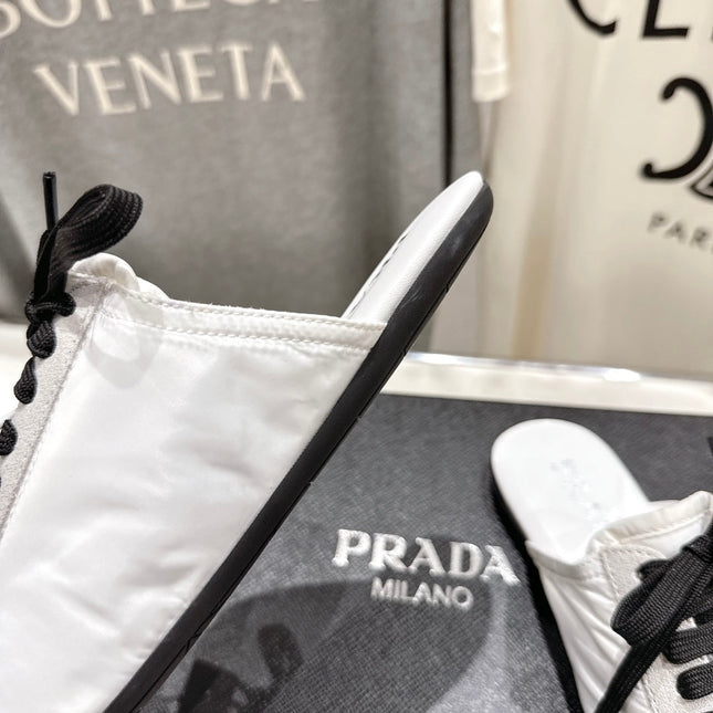 PRADA 25S MULES IN WHITE WITH METAL TOECAP