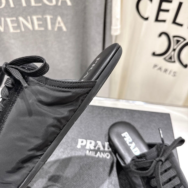 PRADA 25S MULES IN BLACK WITH METAL TOECAP