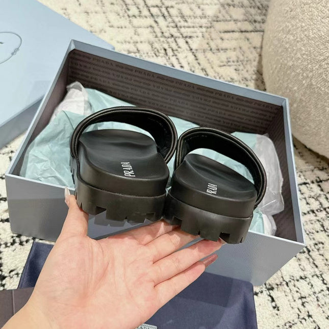 PRADA 25S PADDED SLIDES IN BLACK CALFSKIN WITH LOGO