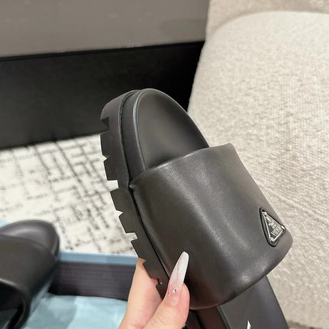 PRADA 25S PADDED SLIDES IN BLACK CALFSKIN WITH LOGO