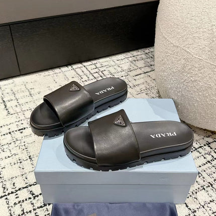 PRADA 25S PADDED SLIDES IN BLACK CALFSKIN WITH LOGO