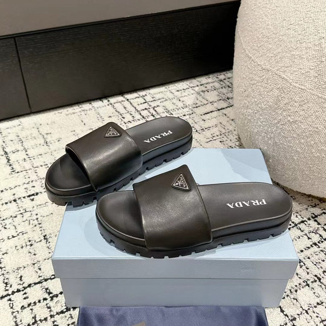PRADA 25S PADDED SLIDES IN BLACK CALFSKIN WITH LOGO