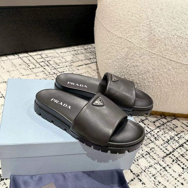 PRADA 25S PADDED SLIDES IN BLACK CALFSKIN WITH LOGO