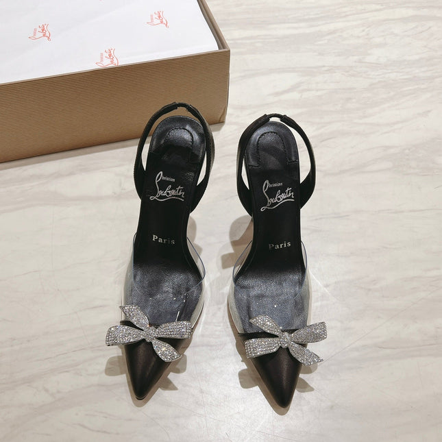 APOSTROPHA SLINGBACK PUMPS IN BLACK CALFSKIN AND CLEAR PVC JEWELED BOW