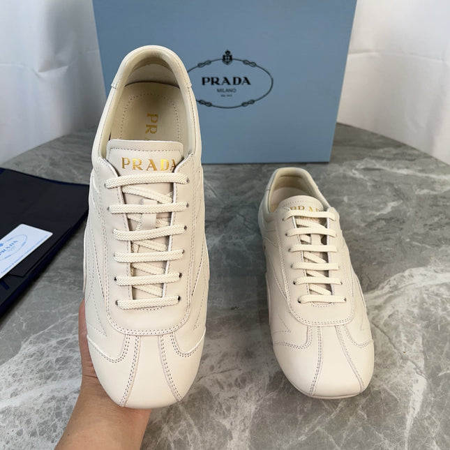 PRADA 25S MONTECARLO ANTIQUED SNEAKERS IN CHALK WHITE NAPPA LEATHER