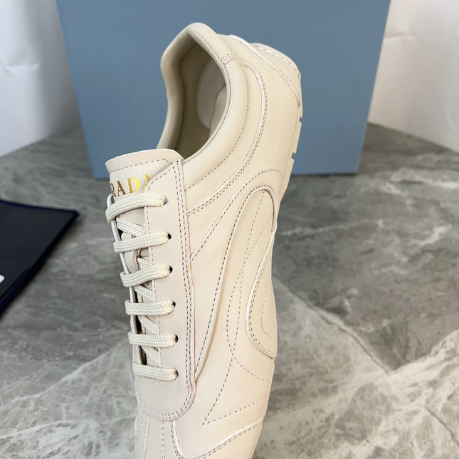 PRADA 25S MONTECARLO ANTIQUED SNEAKERS IN CHALK WHITE NAPPA LEATHER