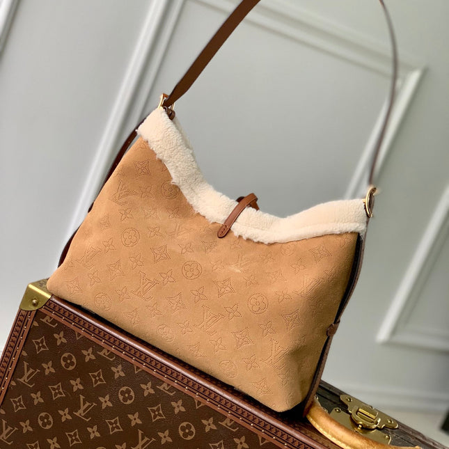 CARRYALL PM 29 IN CIDER BROWN MONOGRAM PERFORATED SUEDE AND WHITE SHEARLING TRIM