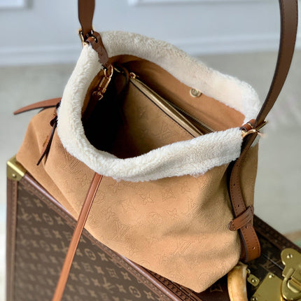 CARRYALL PM 29 IN CIDER BROWN MONOGRAM PERFORATED SUEDE AND WHITE SHEARLING TRIM