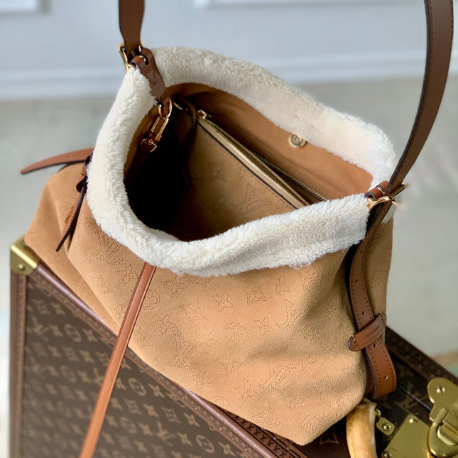 CARRYALL PM 29 IN CIDER BROWN MONOGRAM PERFORATED SUEDE AND WHITE SHEARLING TRIM