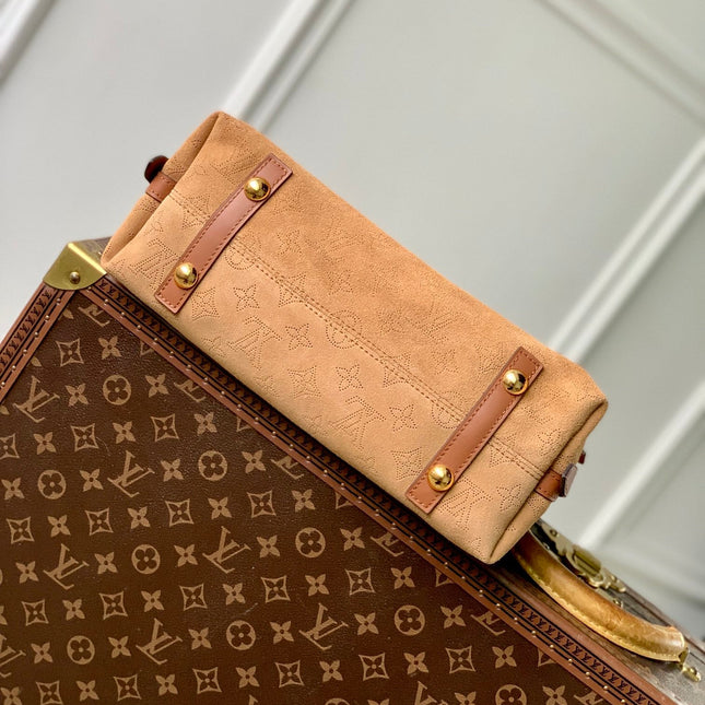 CARRYALL PM 29 IN CIDER BROWN MONOGRAM PERFORATED SUEDE AND WHITE SHEARLING TRIM