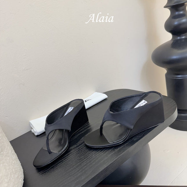 ALAIA WEDGE THONG SANDALS 25S IN BLACK SATIN