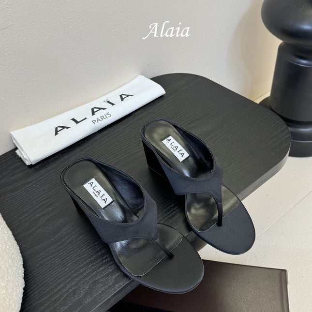 ALAIA WEDGE THONG SANDALS 25S IN BLACK SATIN