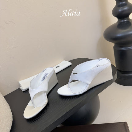ALAIA WEDGE THONG SANDALS 25S IN WHITE SATIN